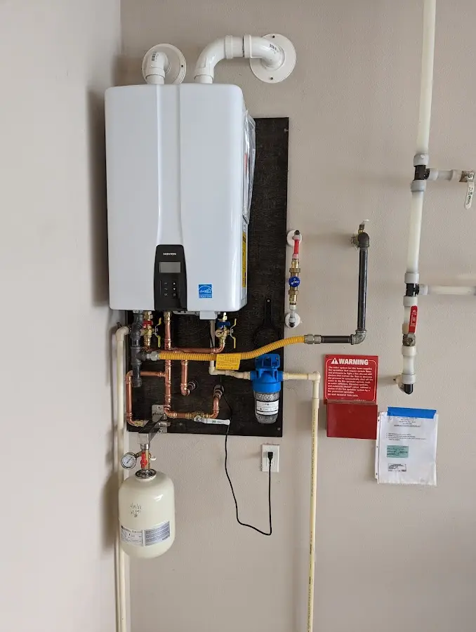 Professional plumber installing copper piping in a Lincoln City home